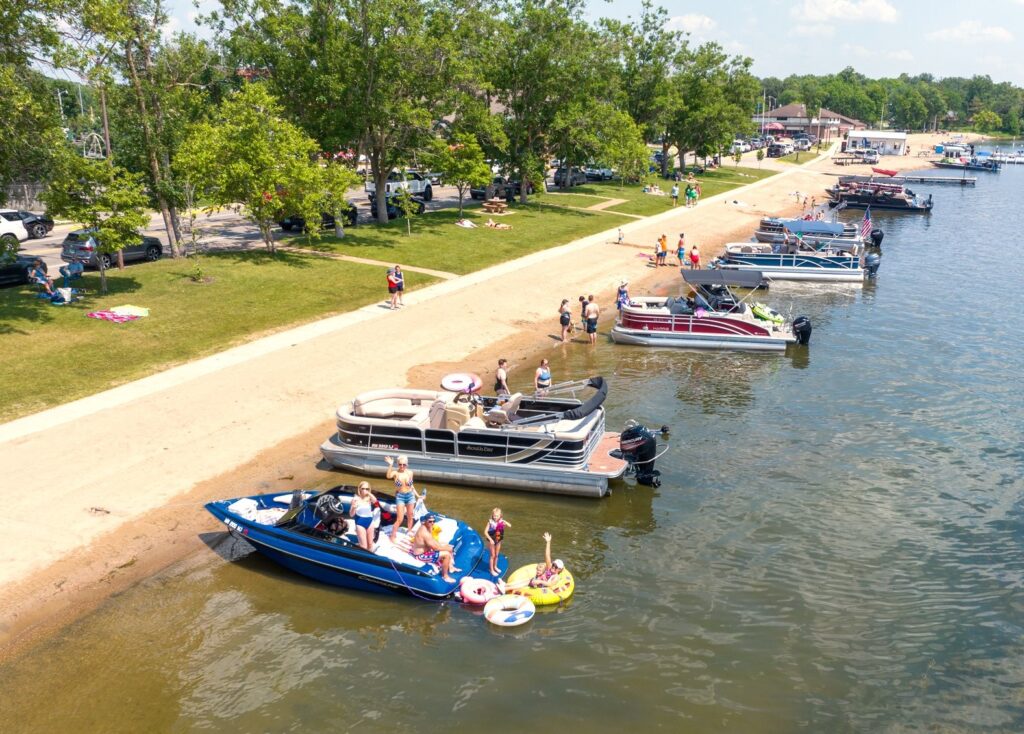 Aerial view of City Beach lined with pontoons on a summer day