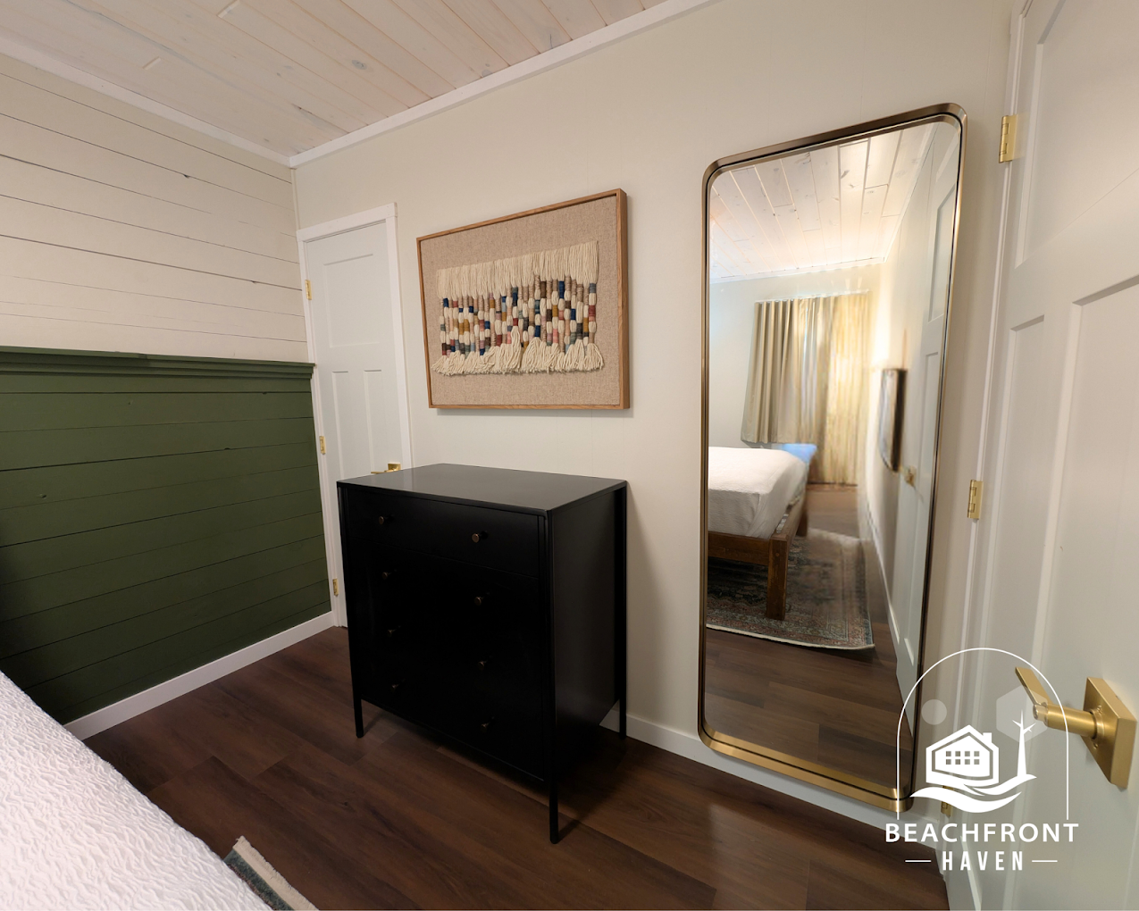 Two-bedroom suite bedroom with green shiplap wall