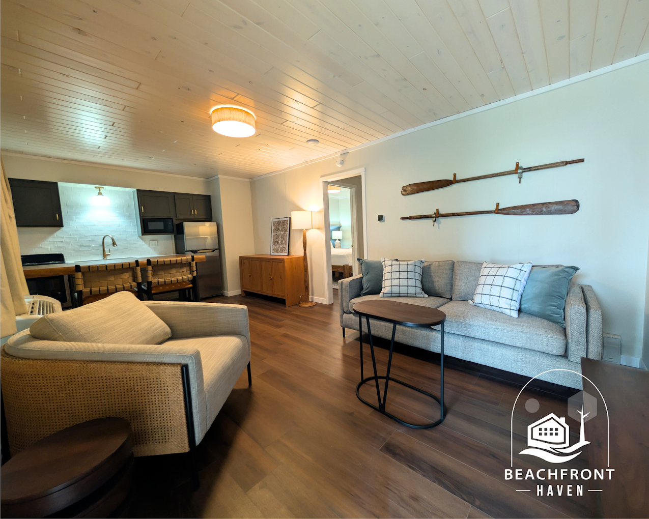 Suite living room with kitchenette and paddles on the wall