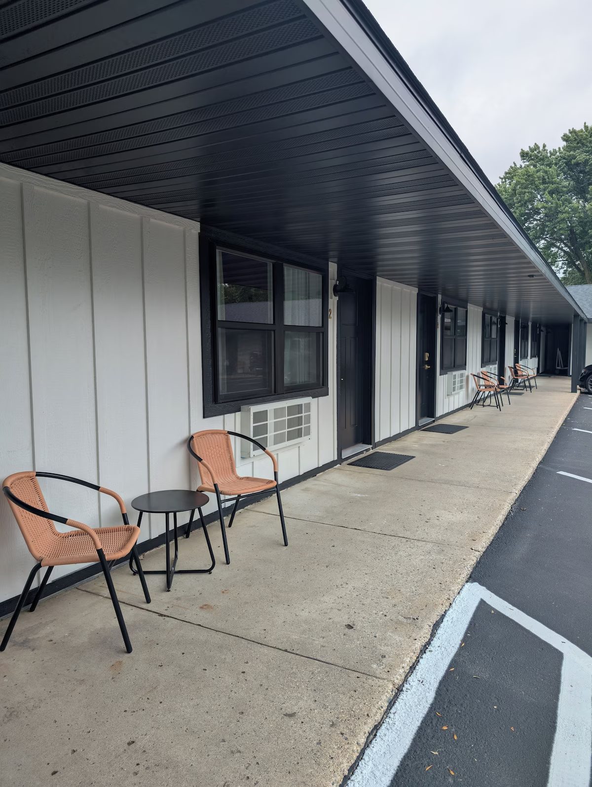 Patio chairs along the front walk of the suites