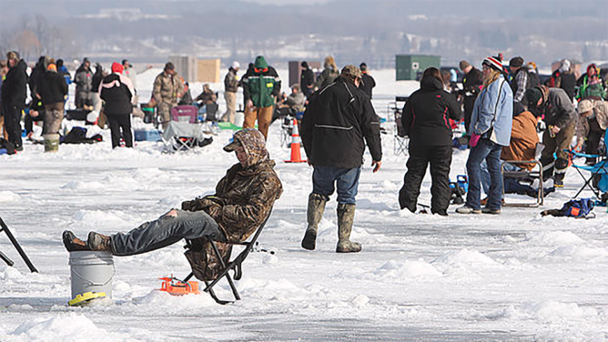 Ice-fishing crowd spread across frozen Detroit Lake with rods and chairs